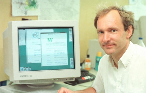 Photo of Tim Berners Lee in front of a computer
