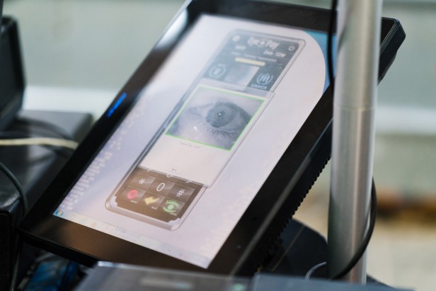 An iris scan is used to establish digital identity at the checkout. The system uses a traditional database and an account stored on a permissioned variant of the Ethereum blockchain.