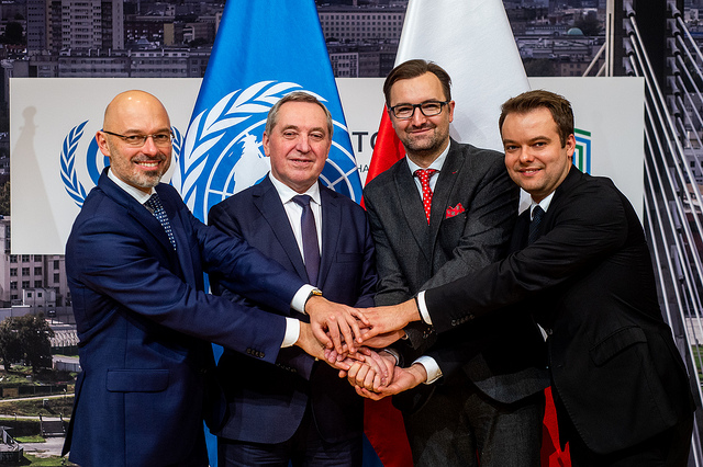 Officials shake hands at the press conference on December 16, 2018 at the UN's COP24 meeting in Poland.