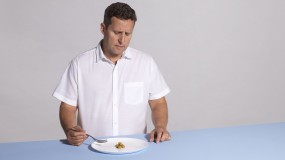 An image of Adam Piore in front of a plate of olives