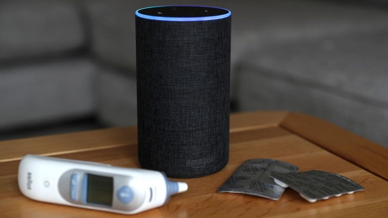 An Amazon Echo with tablets and a temperature probe beside it