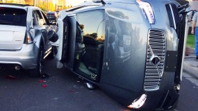 An image showing the aftermath of a self-driving car accident, with an uber vehicle on its side