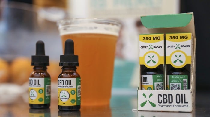 Photograph of CBD oil as well as a beer