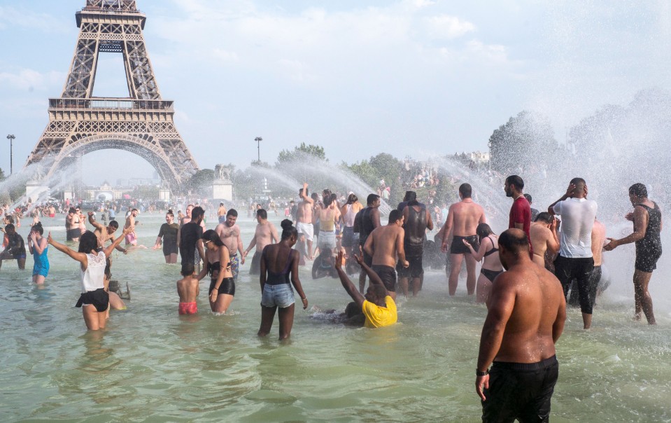 People cool down in the fountains of the Trocadero gardens in Paris, Thursday July 25, 2019