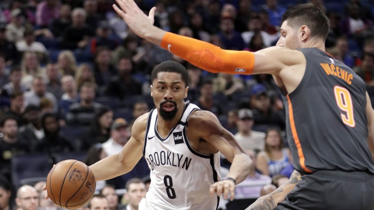 Brooklyn Nets guard Spencer Dinwiddie dribbling past a defender.