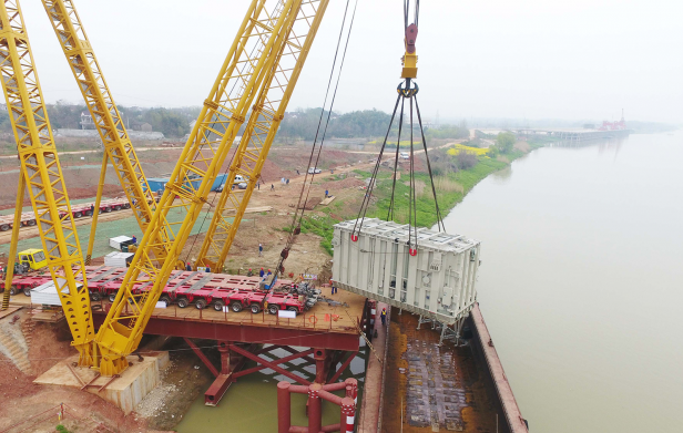 Photograph of a crane lifting the world's most powerful converter transformer, developed for State Grid's 1.1-million-volt transmission line, in China's Anhui province in March 2018.