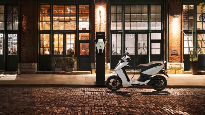 Photo of Ather 4 electric scooter connected to outdoor charging station