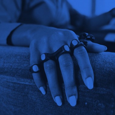 Image of person wearing connected ring typing device that fits over fingers