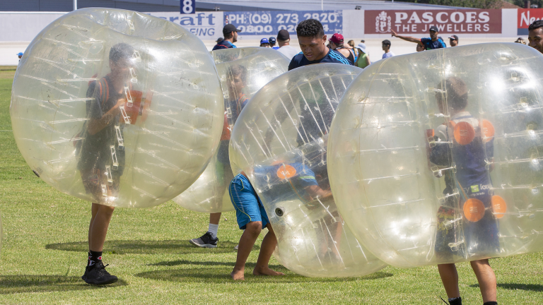 People playing a game where they each are in a bubble.