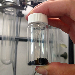 hand holding vial of isomers