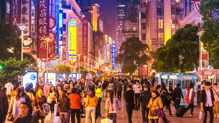 A crowd of people walk in Shanghai.