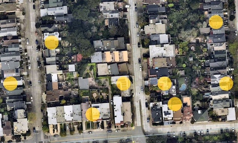 A Google Maps photo of rooftops with solar panels highlighted
