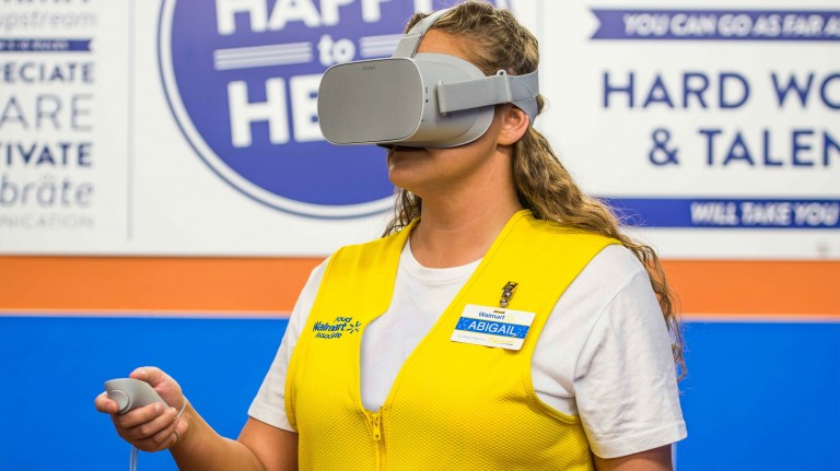 Image of a Walmart worker using a VR headset.