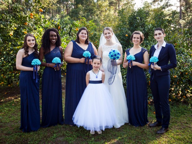 Photo of bridal party holding 3-d printed bouquets.