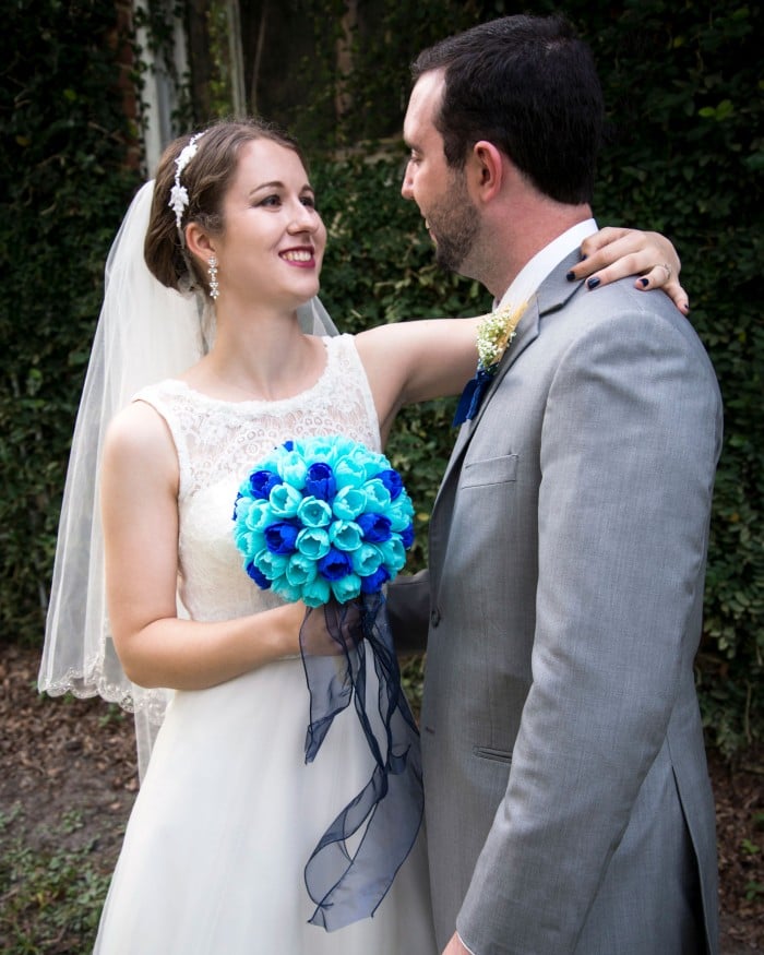 Erin standing with her husband holding her bouquet