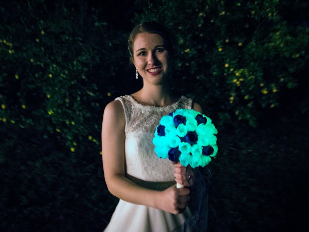Erin holding glow-in-the-dark 3-d printed flower bouquet
