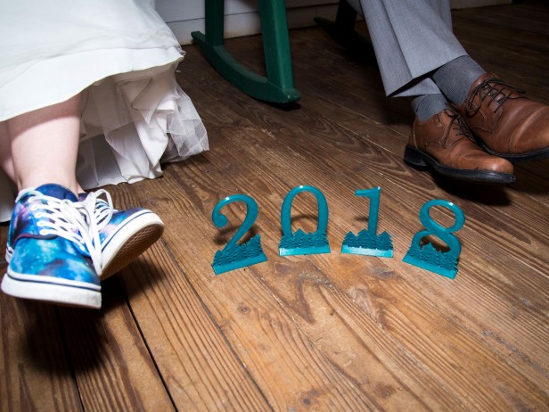 Erin and groom Alex's feet beside 3-D printed numbers "2018"