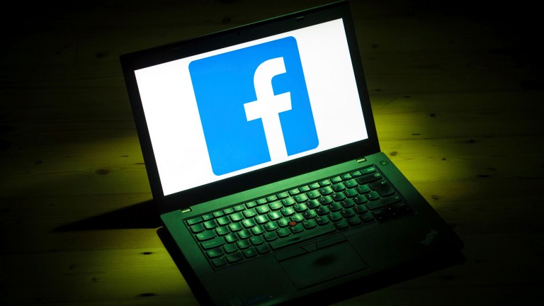 Facebook's logo taking up an entire open laptop screen