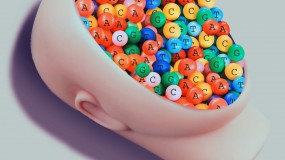 Photo illustration of a doll's face filled with colorful beads each containing a letter of a nucleotide. A black, unmarked bead appears in a set of tweezers above the face.