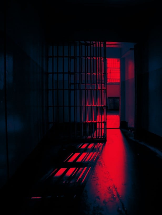 A prison cell with an open door