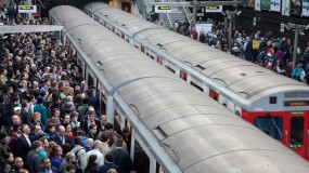 An image of people crowding onto train cars.