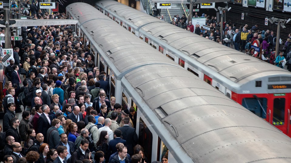 An image of people crowding onto train cars.