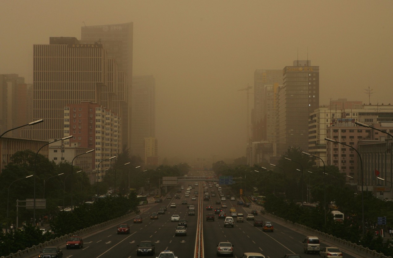 An image of a busy Bejing road covered  in smog