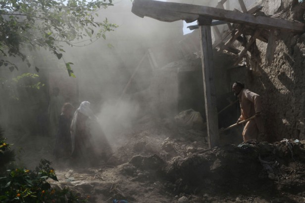Afghan residents clear rubble from their homes.