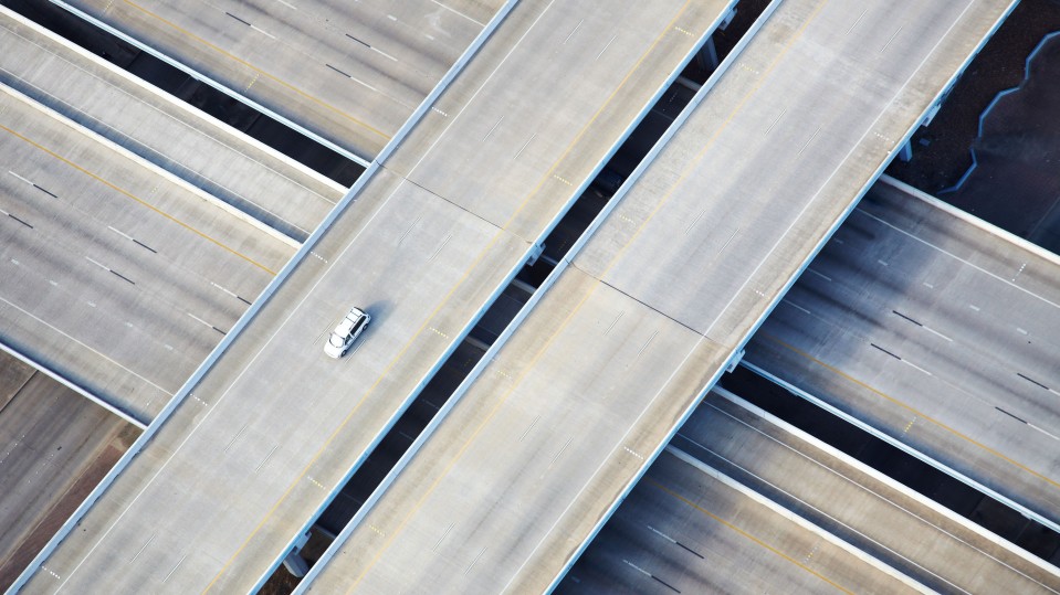 photograph of a single car on an highway