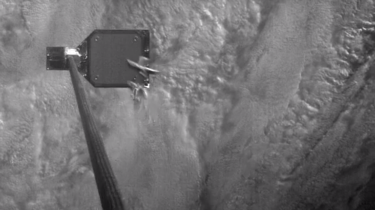 Video of harpoon slamming into a satellite panel with Earth in the background