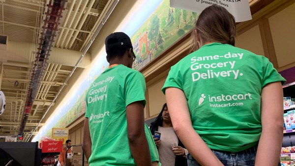 Instacart workers receive instruction in a store
