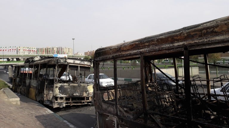 Scorched public buses that remained on the street in Tehran, Iran, after protests that followed authorities' decision to raise gasoline prices