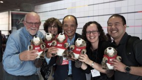 Photo of volunteers holding beaver stuffed animals