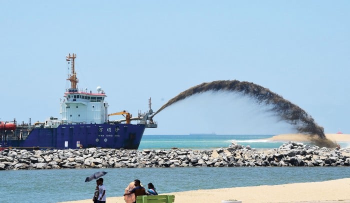 Photograph of the Wan Qing Sha, a trailing suction hopper dredger, helps build a new city off the coast of Colombo as part of a massive Chinese infrastructure project, the largest foreign investment in Sri Lanka's history.
