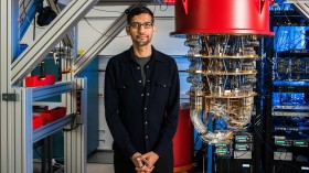 Photograph of Sundar Pichai standing next to a quantum computer at Google