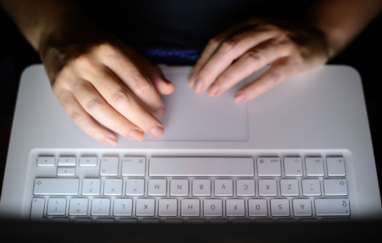A photo of someone using a laptop keyboard