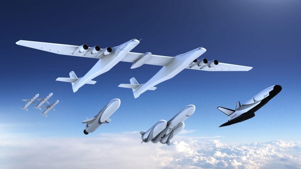 Image of Stratolaunch plane and newly announced rockets flying in the sky.