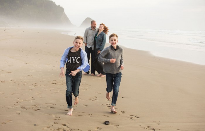 Photo of mother, father, and two children on the beach