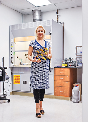 Greer in her Caltech lab, holding a model of the atomic structure of a metal.