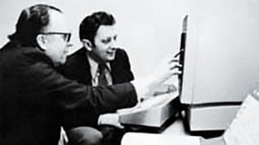 Photo of JCR Licklider and Al Vezza in front of a computer