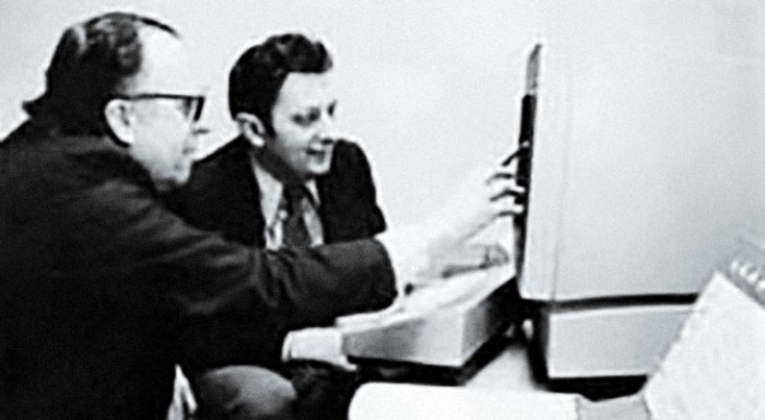 Photo of JCR Licklider and Al Vezza in front of a computer
