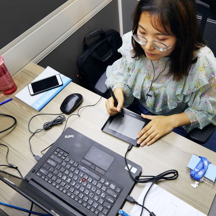A woman working at a laptop