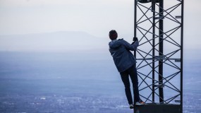image of person hanging off cell phone tower 5g cancer fda report fcc