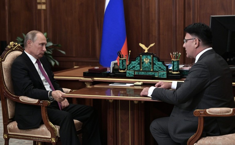 Russian President Vladimir Putin with the head of the country's telecoms regulator, Alexander Zharov