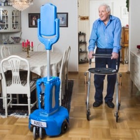 senior man using walker towards blue robot