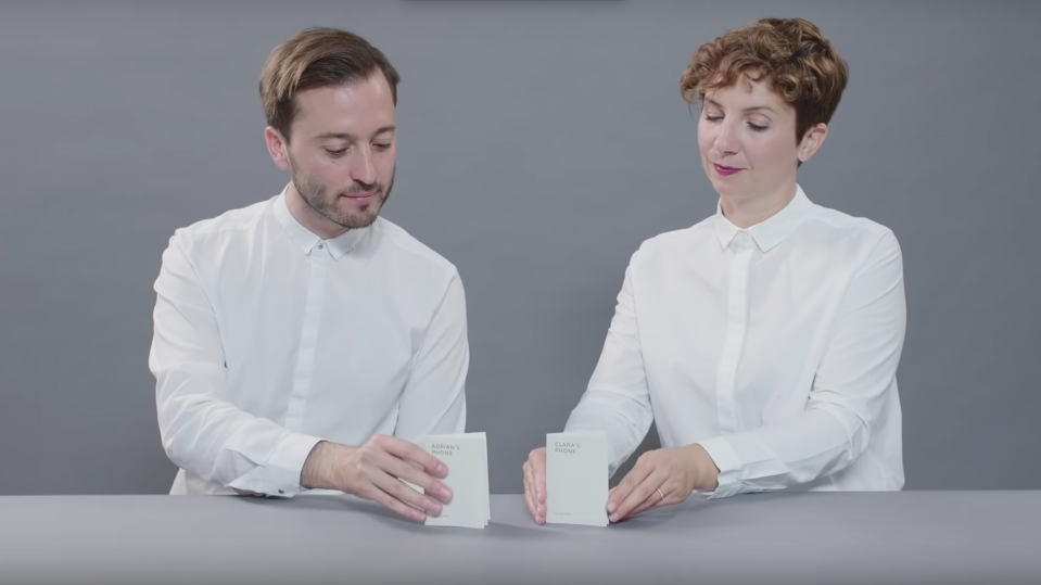 google special projects experiments digital wellbeing two people a man and a woman in white shirts with paper phone on table