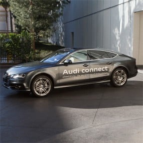 Audi automobile with "Audi connect" signage painted on driver's side doors
