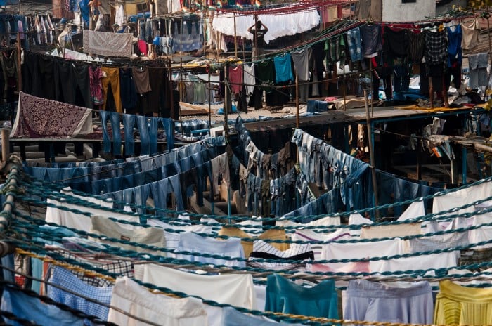 Image of a small outdoor area filled with clotheslines for air drying clothing and fabric after washing