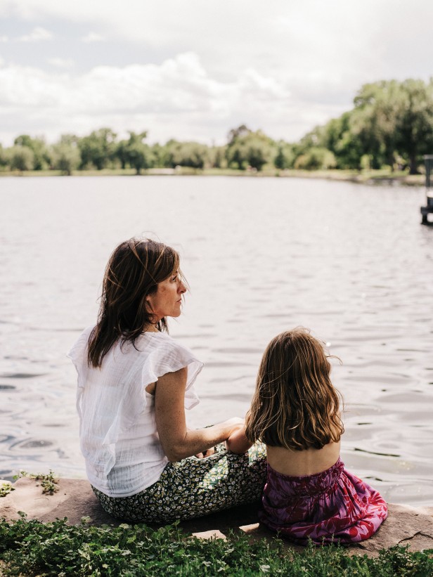 Photograph of Michele Krumper and her daughter sitting out by a lake