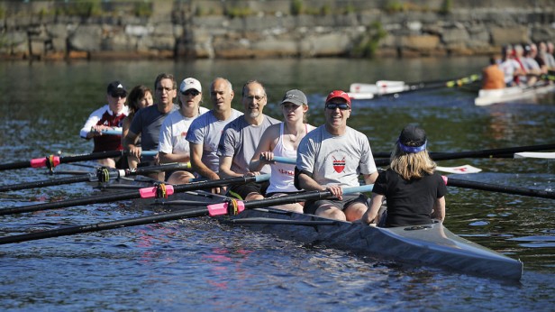 Eight boats filled with alumni, most veterans of MIT Crew, take to the Charles River for Reunion Row, a Tech Reunions tradition in its third decade.